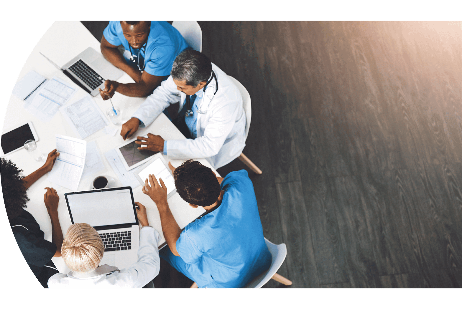 Medical professionals sitting around a table discussing topics related to ROI of safety solutions.