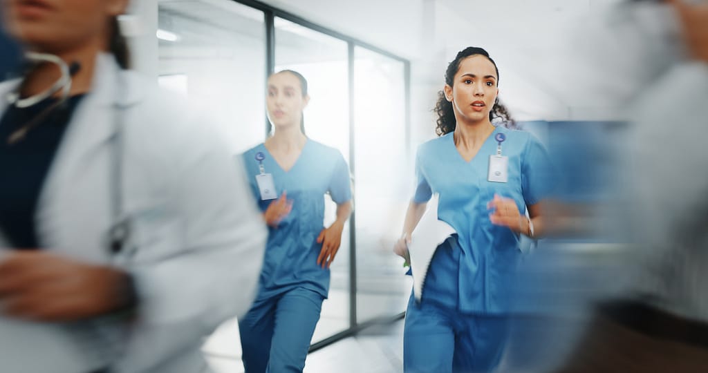 Nurses wearing CrisisAlert badges running to assist in an emergency